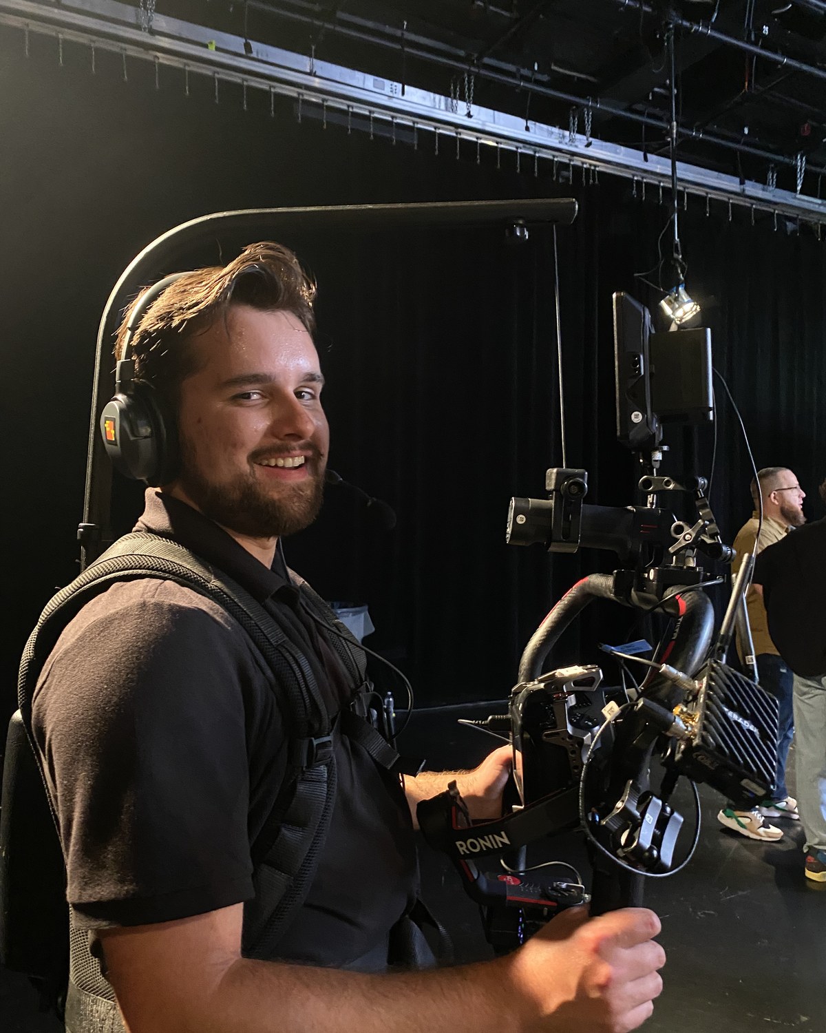 Grayson operating a gimbal-mounted cinema camera on set